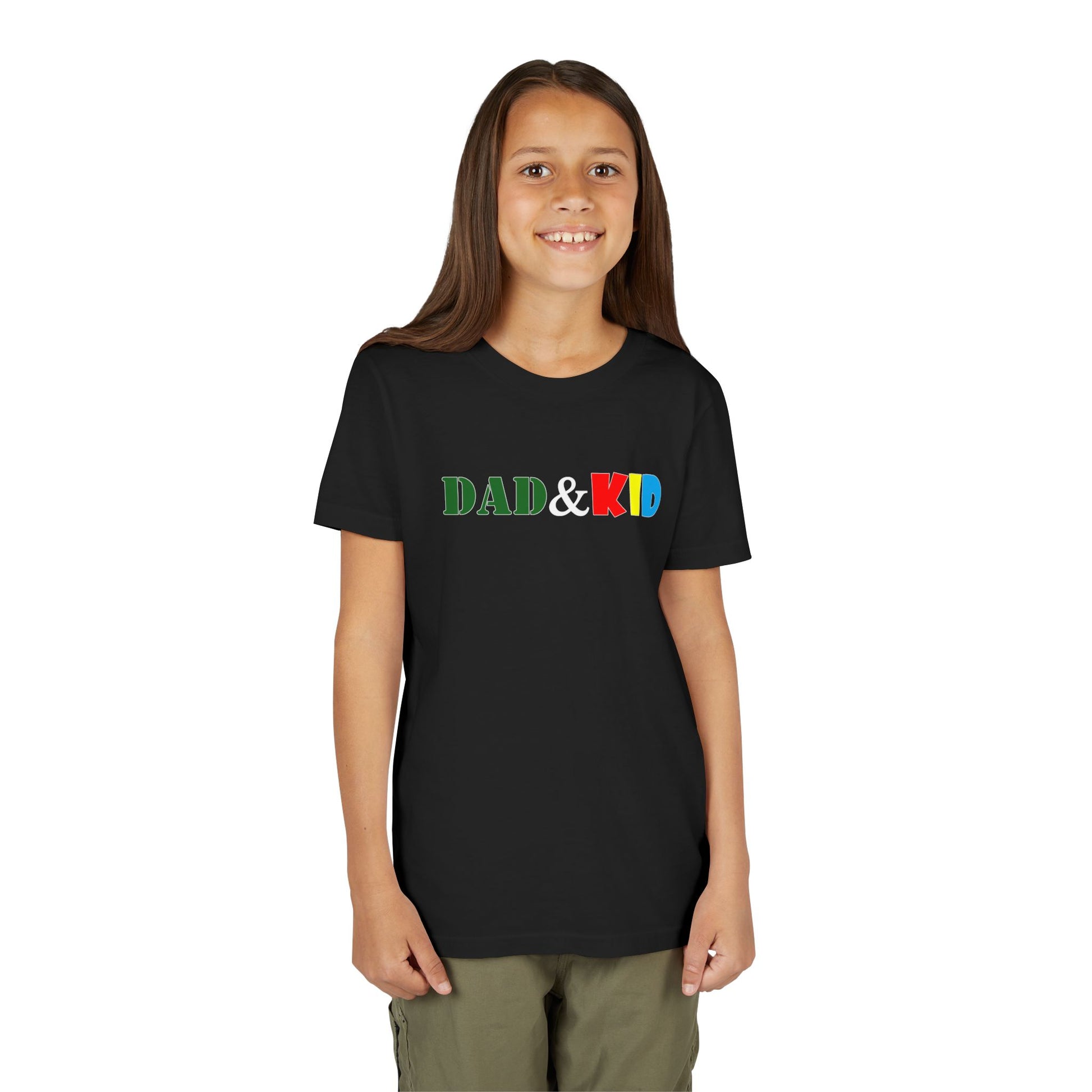 Young girl wearing a black t-shirt with 'DAD & KID' text in colorful letters on a white background